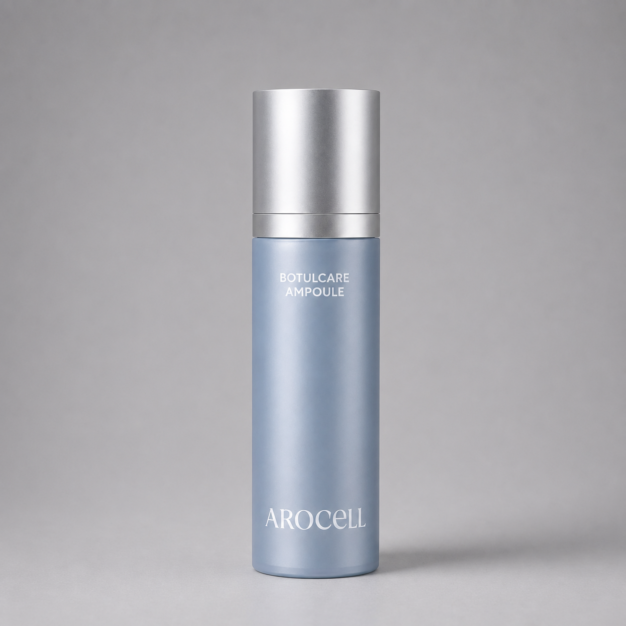 A light blue cylindrical cosmetic bottle with a metallic silver cap, labeled 'BOTULCARE AMPOULE' and 'AROCELL', centered on a neutral gray background.