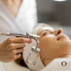 A person receiving an oxygen facial treatment on their face.