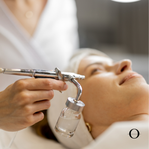 A person receiving an oxygen facial treatment on their face.