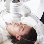 Person receiving a facial treatment with a machine on their face