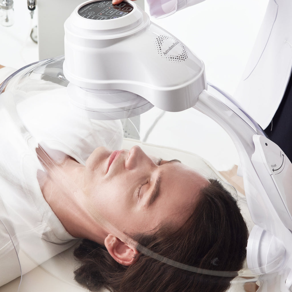 Person receiving a facial treatment with a machine on their face