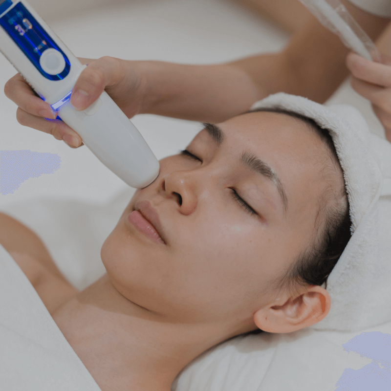 Person receiving a facial treatment with a device on their face