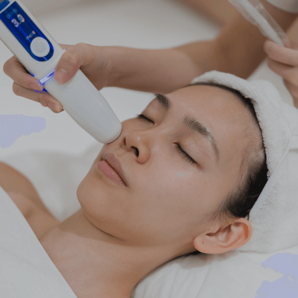 Person receiving a facial treatment with a device on their face