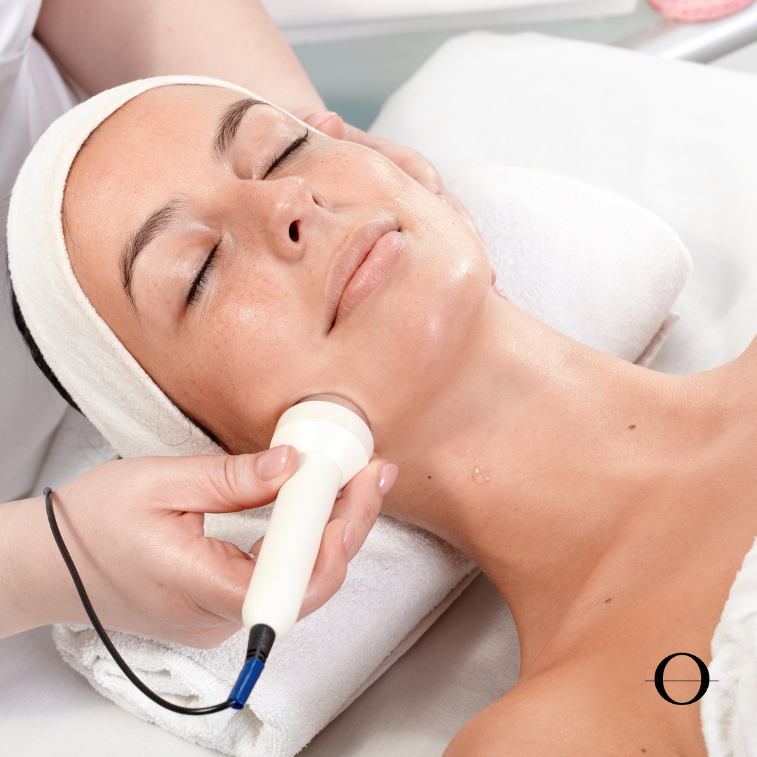Woman receiving a facial treatment with a device on her face.