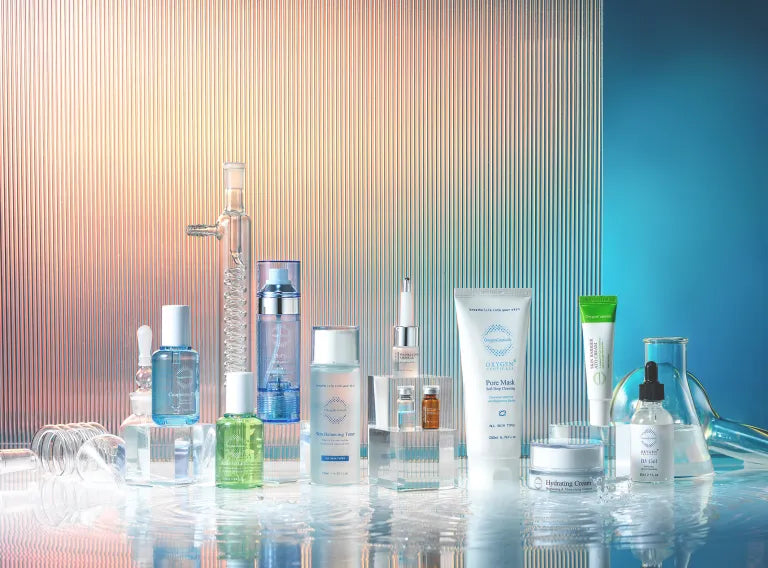 Collection of skincare products on a reflective surface with a gradient background